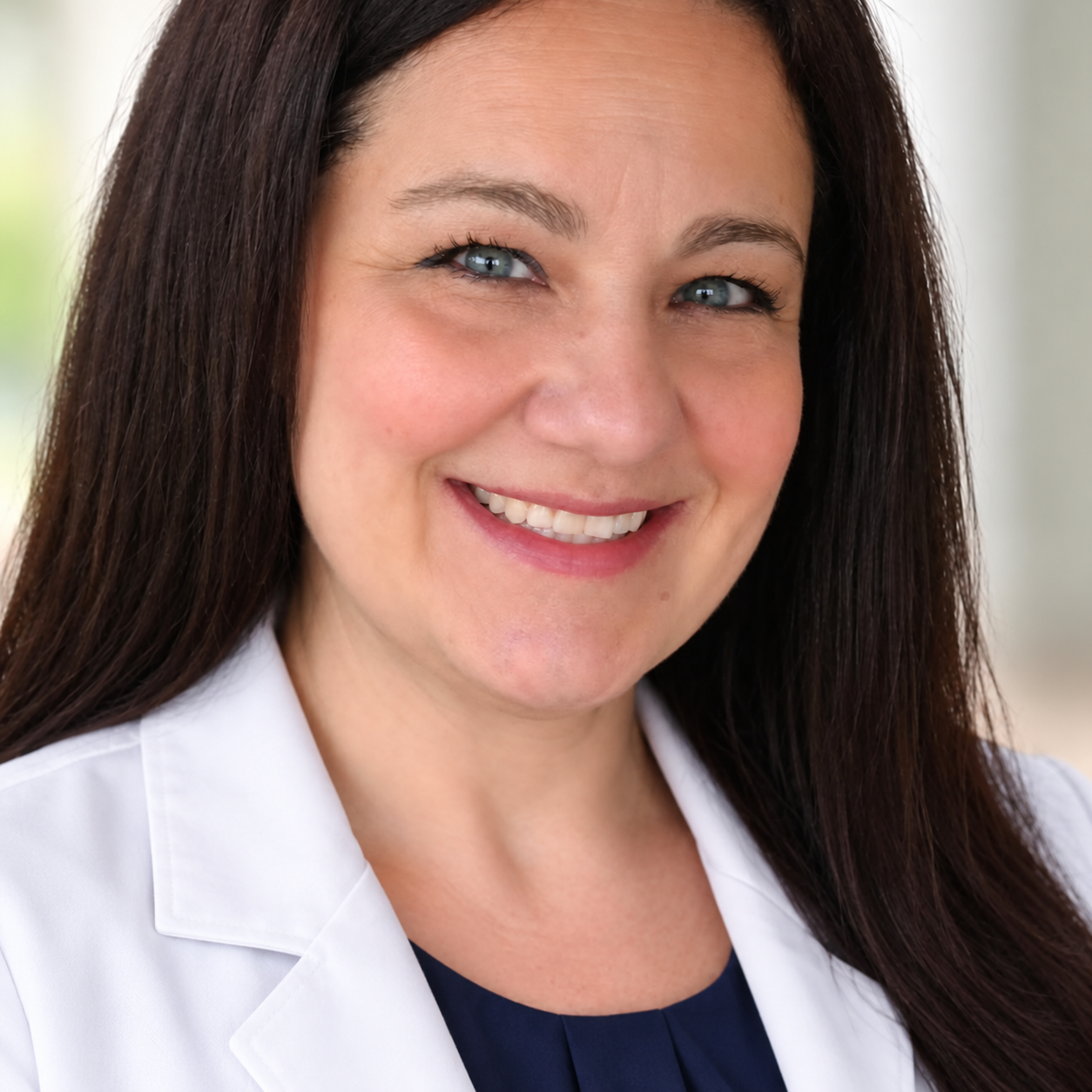 Kristina Sifuentes wearing a professional white clinical jacket